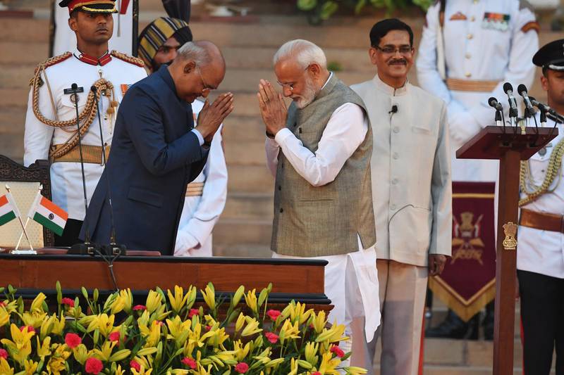 Newly sworn-in Indian Prime Minister Narendra Modi gestures towards Indian President Ram Nath Kovind. AFP