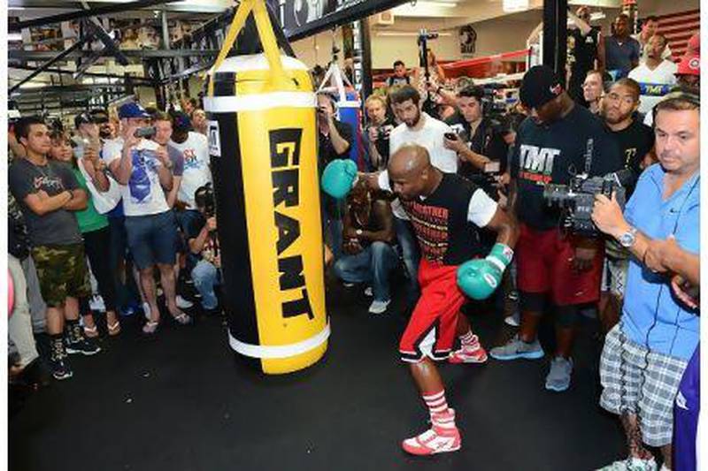 No stranger to fan support or cameras, boxer Floyd Mayweather Jr hits a heavy bag during a training session in Las Vegas on Thursday. Ethan Miller / AFP