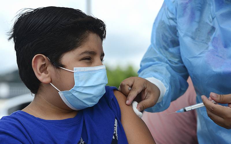 A boy receives the first dose of the Pfizer/BioNTech Covid-19 vaccine in Tegucigalpa during a vaccination programme for teens aged 12 to 15.  AFP
