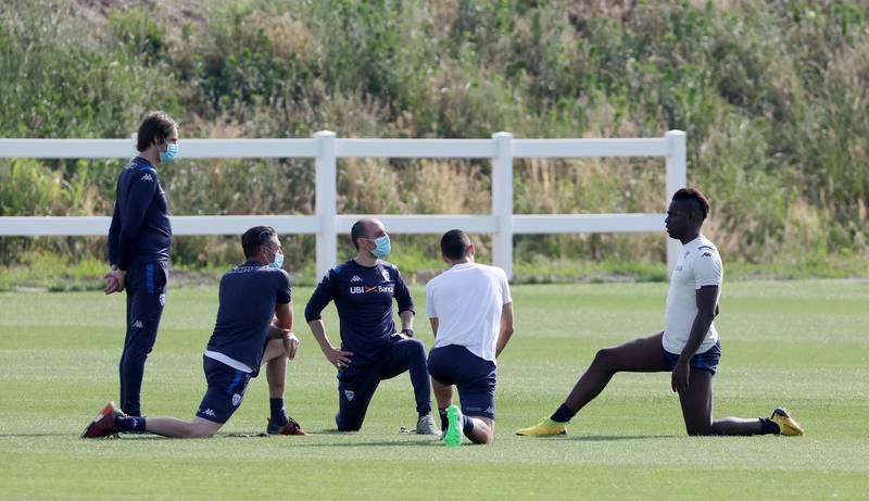 Mario Balotelli and fellow Bresica players stretch during a training session. EPA
