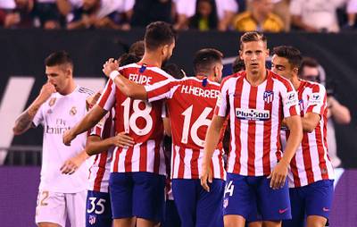 Atletico celebrate their seventh goal against Real. AFP