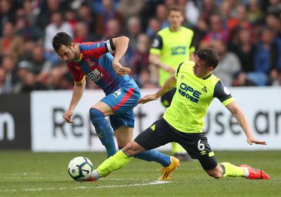 Milivojevic in action with Huddersfield Town's Jonathan Hogg. Reuters