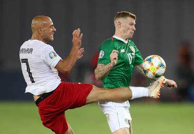 Republic of Ireland's James McClean, right, battles for possession with Jaba Kankava of Georgia. Reuters