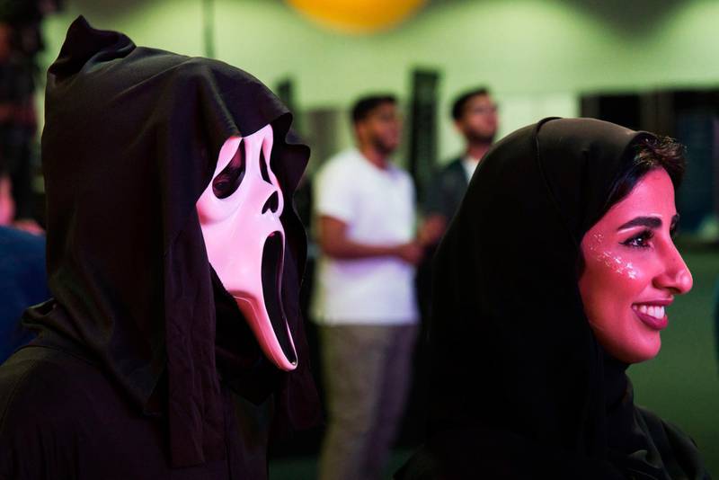 Two Emiratis watch a dance-off. AP Photo