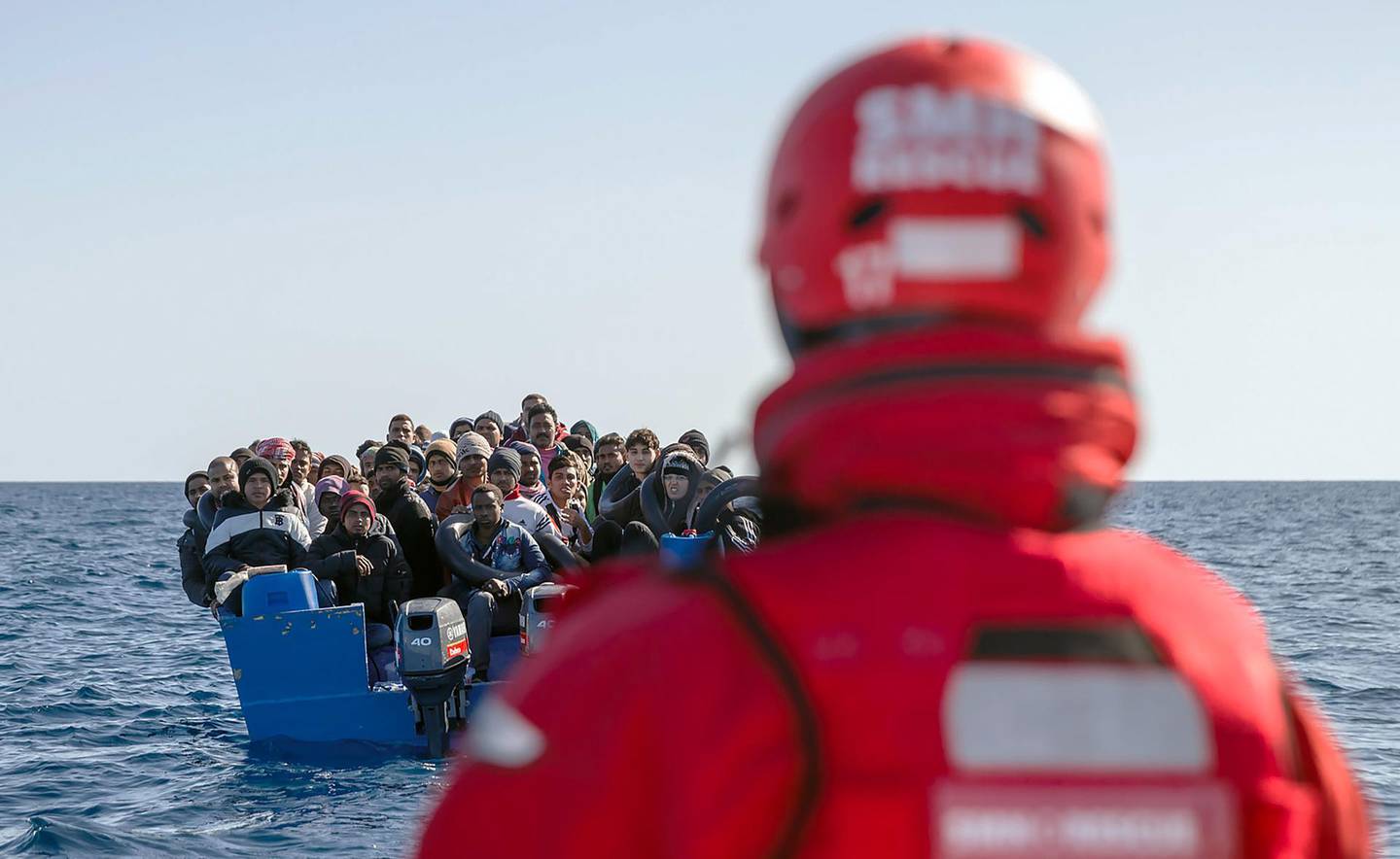 Migrants from Bangladesh, Afghanistan and Pakistan wait for being taken to the Spanish NGO Maydayterraneo's Aita Mari rescue boat during the rescue of 65 migrants in the Mediterranean international waters off the Libyan coast on February 10, 2020. With the 65 people rescued today, a total of 158 migrants are aboard the Spanish rescue boat Aita Mari after yesterday other group of 93 African migrants were rescued by the Maydayterraneo NGO off the coast of Libya. / AFP / Pablo Garcia
