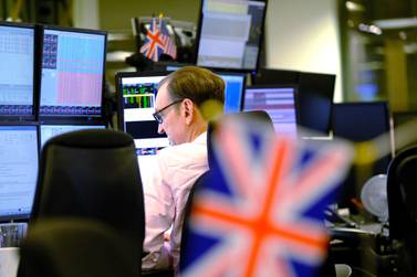 A trader monitors financial data on computer screens as he works on the trading floor at ETX Capital, a broker of contracts-for-difference, after the U.K. general election, in London. The pound initially soared, but then tumbled as much 1.7% following prime minister Boris Johnson’s plans to set a Brexit deadline of December 2020.