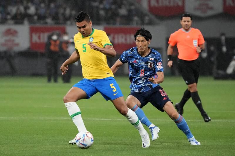 Brazil's Casemiro controls the ball under pressure from Japan's Genki Haraguchi during a friendly match in Tokyo on June 6, 2022. Getty 