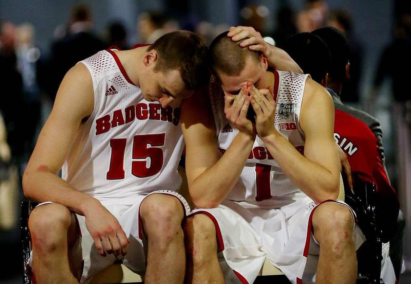 Sam Dekker, left, and Ben Brust, right, of Wisconsin react after losing to Kentucky on Saturday. Ronald Martinez / Getty Images /AFP / April 5, 2014