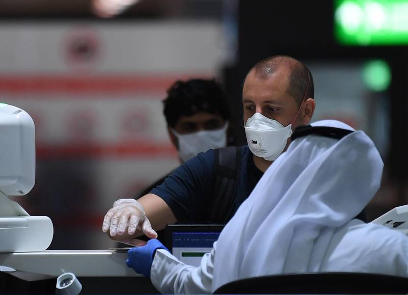 Passengers have their travel documents checked before departure at Dubai International Airport. AFP