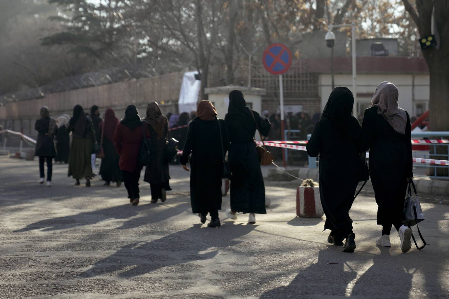 Students walk to Kabul University on February  26, 2022 as classes resumed after a gap of six months. AP Photo