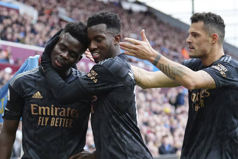 Arsenal's Bukayo Saka (l) celebrates with Eddie Nketiah and Granit Xhaka after levelling at 1-1. AP