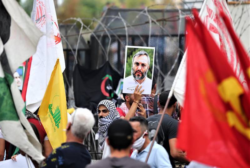 Protesters carry a picture of Hezbollah commander Imad Moughnyeh during a demonstration by supporters of Hezbollah, Lebanese communist party, and other Lebanese national parties at the US embassy against US interference in Lebanon's affairs, in Awkar area northeast Beirut, Lebanon. EPA