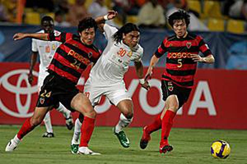 Umm Salal's Brazilian player Davi, centre, is outmuscled by two Pohang defenders in Doha on Wednesday.