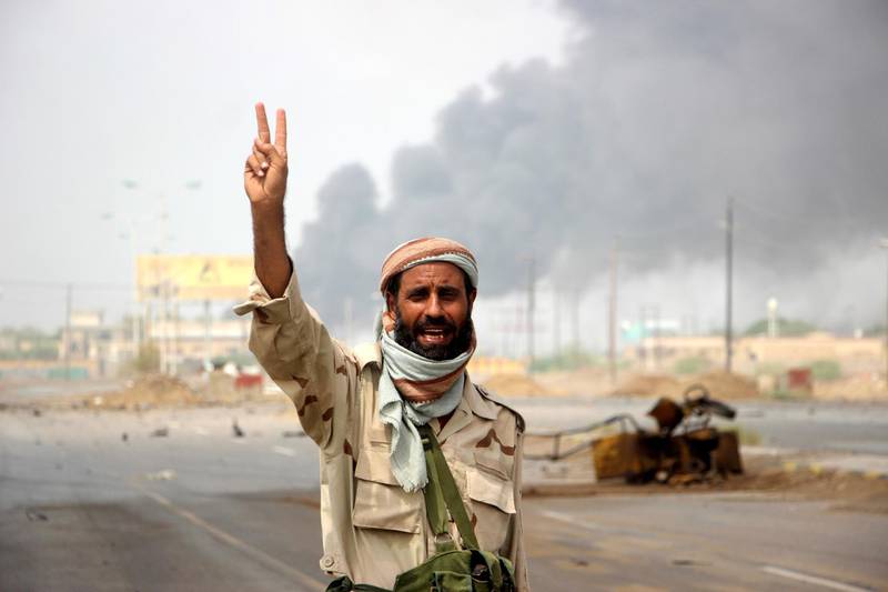 A member of Yemeni government forces flashes a Victory sign during battles between Yemeni government forces and Houthi rebels in the port city of Hodeidah, Yemen. EPA