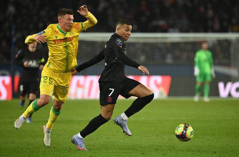 Paris Saint-Germain's French forward Kylian Mbappe fights for the ball with Nantes' French midfielder Batista Mendy. AFP
