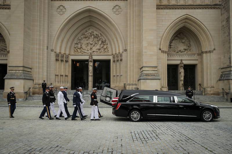 A joint service military casket team prepares to unload the casket of the  Senator John McCain at the Washington National Cathedral for the funeral service.  Getty Images/AFP