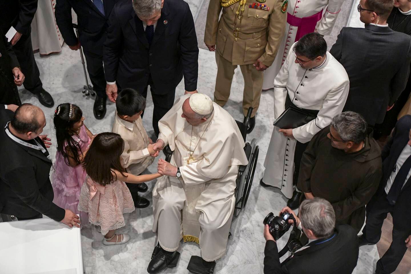 Pope Francis greets young children at the Cathedral of Our Lady of Arabia, Bahrain. Khushnum Bhandari / The National