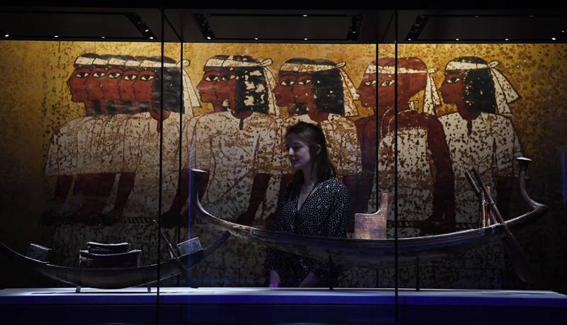 A visitor looks at a painted wooden model solar boat with throne and steering paddles (R) during a press preview for the exhibition 'Tutankhamun: Treasures of the Golden Pharaoh' at the Saatchi Gallery in Chelsea in London, Britain, 01 November 2019. EPA