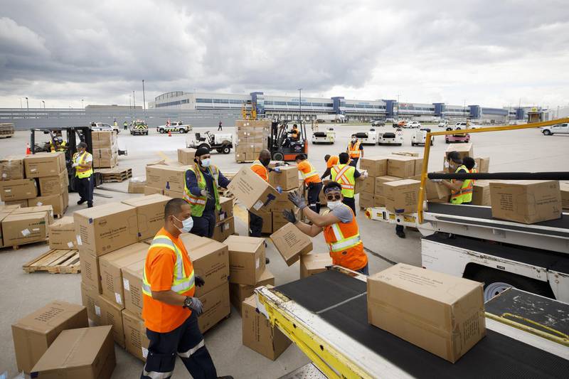 Workers unload a shipment of medical supplies from an Antonov AN-225 Mriya aircraft at Toronto Pearson International Airport. Bloomberg