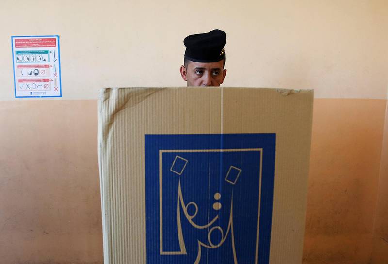 An Iraqi security member casts his vote at a polling station in Mosul, Iraq. Khalid al-Mousily / Reuters