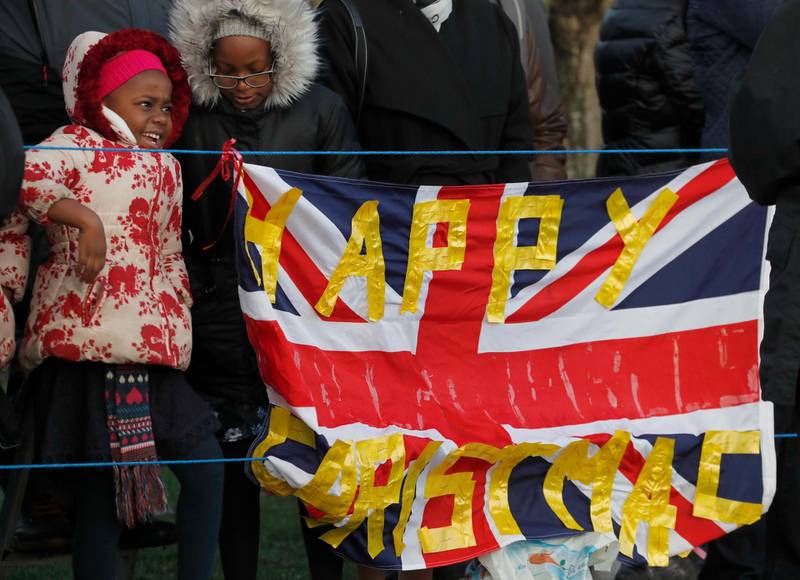 Royal fans wait for the arrival of Britain's Royal family to attend the Christmas day service at St Mary Magdalene Church in Sandringham in Norfolk, England.  AP
