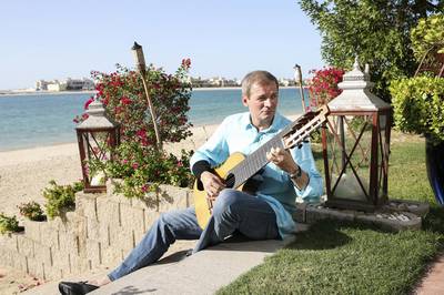 Helmut M. Schuehsler, CEO of TVM Capital, plays guitar at his Palm Jumeirah home in Dubai. Sarah Dea / The National