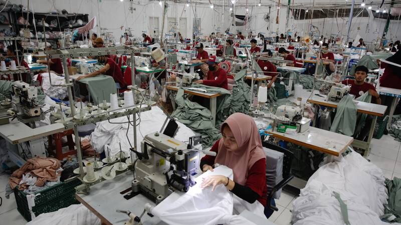 Workers sew women's prayer clothes called Mukenah at the Siti Khadijah clothing factory in Depok, Indonesia.  EPA 