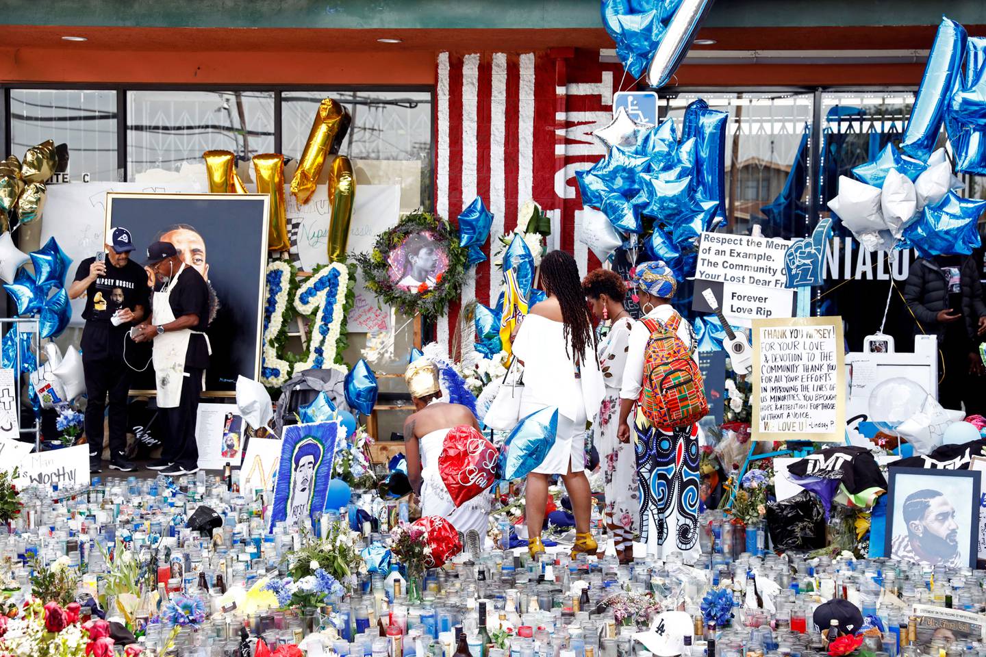People mourn the death of Nipsey Hussle outside his Marathon clothing store in Los Angeles on April 7, 2019. Reuters