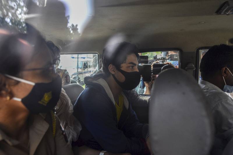 Bollywood actor Shah Rukh Khan’s son, Aryan Khan, sits inside a vehicle outside the Narcotics Control Bureau ahead of his appearance before a court in Mumbai, India, on October 4, 2021.  AP