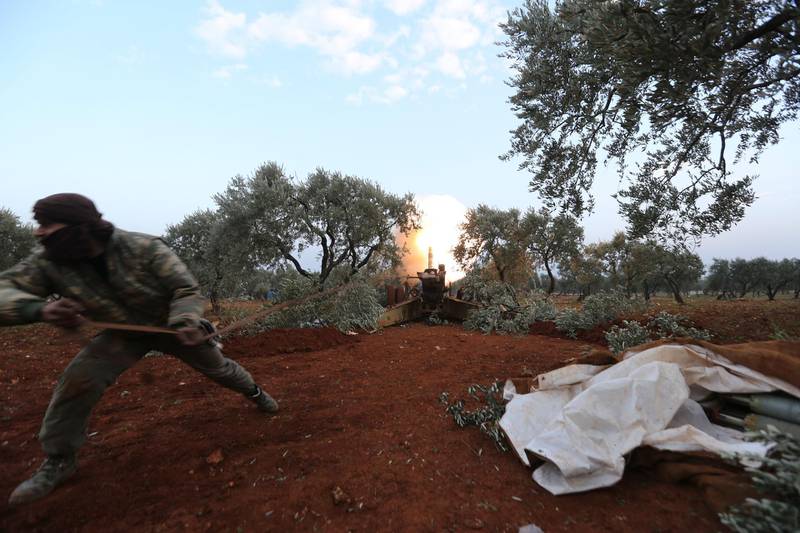 Syrian rebel fighter fire a howitzer toward the government positions near the village of Nerab, in Idlib provinced. AP Photo