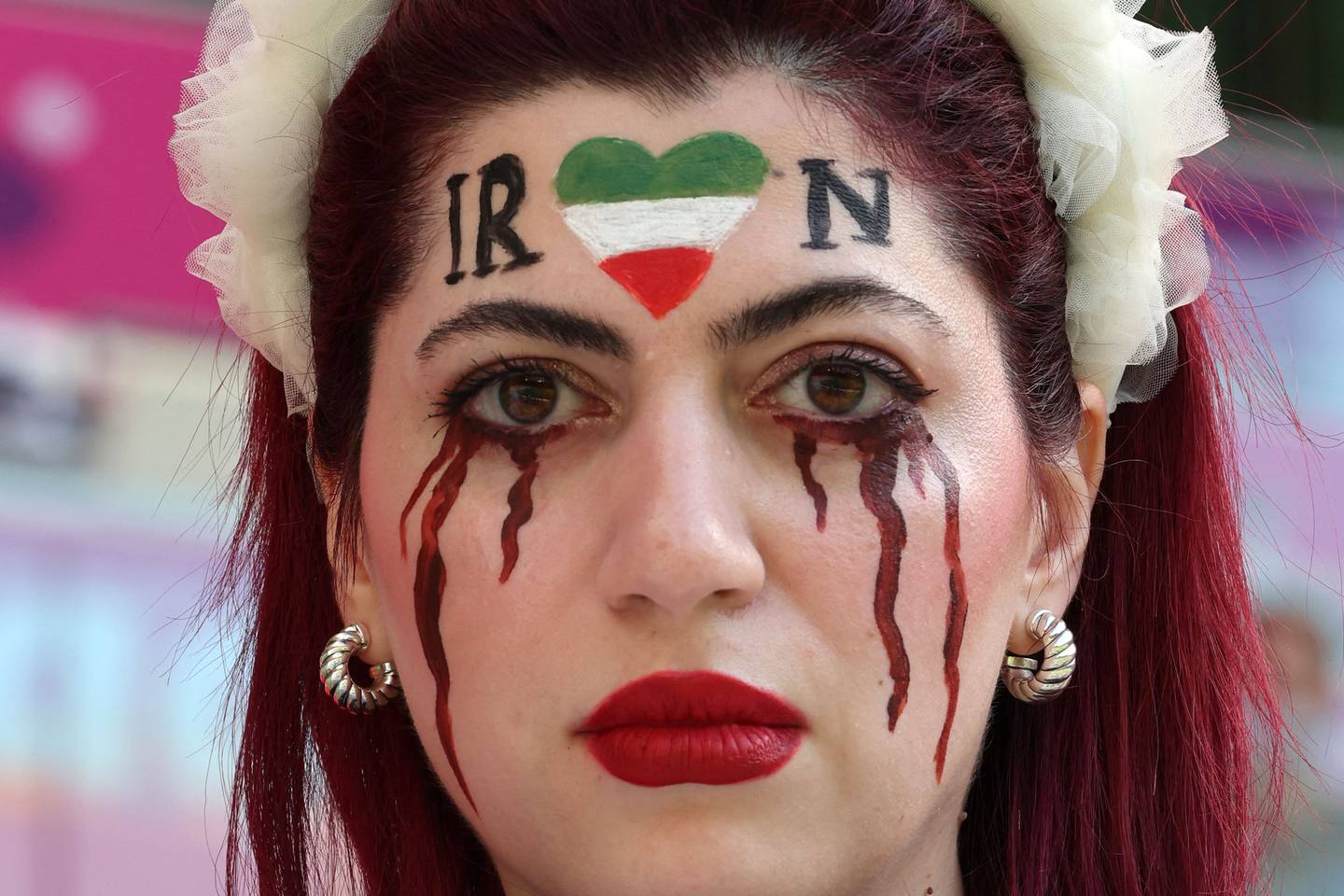 An Iran supporter with her face made up to show tears of blood at the World Cup Group B football match agianst Wales. AFP