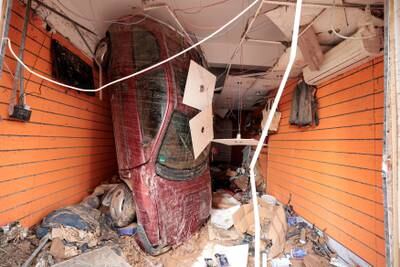 An upturned car inside a shop where it was carried by a torrent of floodwater in Derna, Libya. Reuters