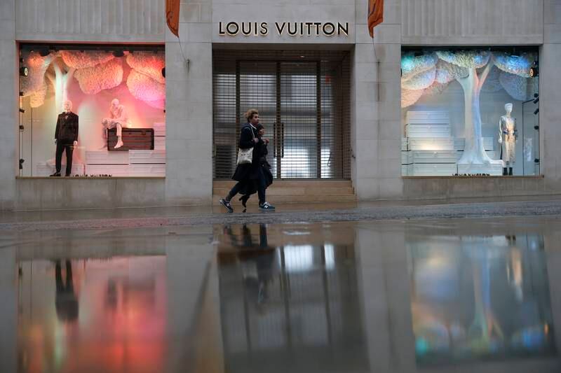 Pedestrians walk past the Louis Vuitton store on New Bond Street in Mayfair, London, in 2021