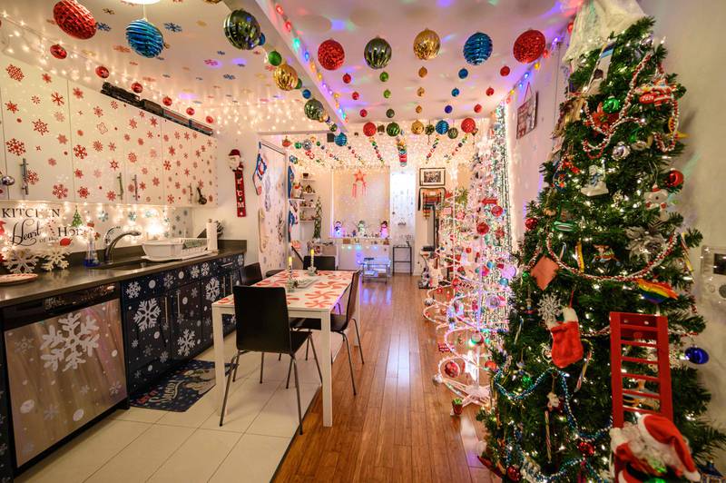 One New Yorker has 12 festive trees and 13,751 lights surrounding other themed trinkets throughout his one-bedroom apartment, which he decorates each year to spread 'joy and happiness'.  AFP
