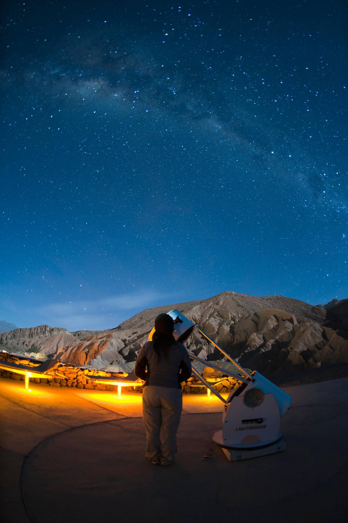 Woman looking at Milky Way, Hotel Alto Atacama, San Pedro de Atacama, Atacama Desert, Chile. Getty Images
