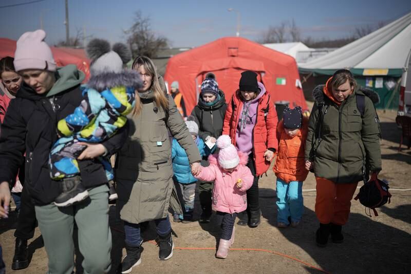 Refugees fleeing Ukraine are receiving aid from the International Red Cross and other charitable organisations at the Vysne Nemecke border. Getty Images