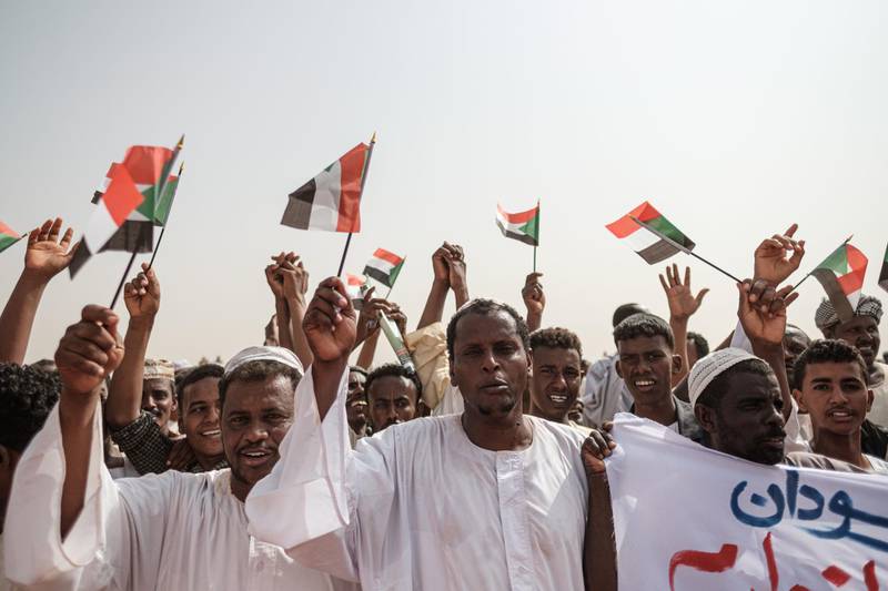 Supporters wave miniature Sudanese national flags as they wait for the deputy head of Sudan's ruling Transitional Military Council (TMC) and commander of the Rapid Support Forces (RSF) paramilitaries to arrive for a rally in the village of Abraq, about 60 kilometres northwest of Khartoum.  AFP