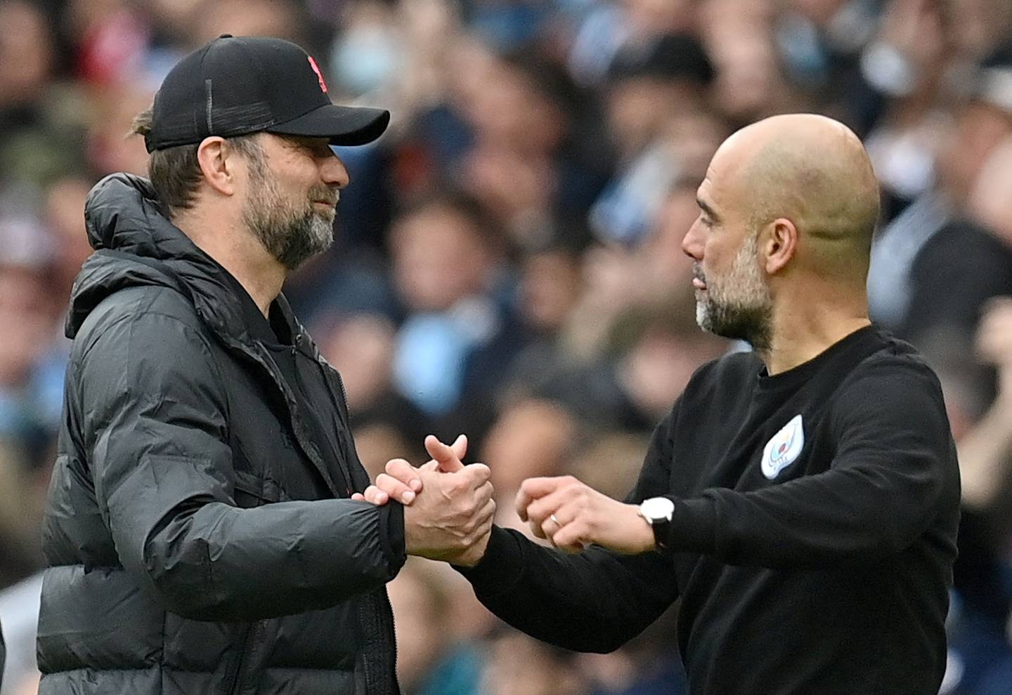 Jurgen Klopp and Pep Guardiola have developed strong bonds with their players and fans. Erik Ten Hag will need to achieve similar. AFP  