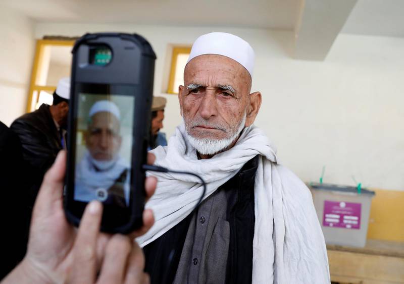 An election official scans a voter's eye with a biometric device at a polling station during a parliamentary election in Kabul, Afghanistan, October 20, 2018. REUTERS/Mohammad Ismail