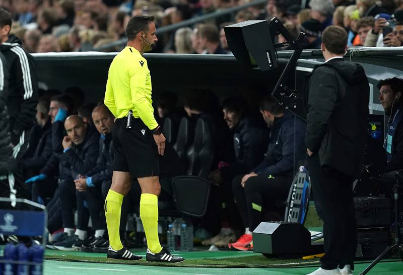 Referee Artur Soraes Dias carries out a VAR check before disallowing Rodri's goal for Manchester City. PA