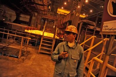 A worker stands near the production line in Khuzestan steel company on September 28, 2011 in Ahwaz, Khuzestan province, southern Iran. Getty