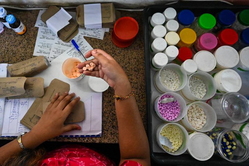 A health worker packs medicines in the hospital. AFP