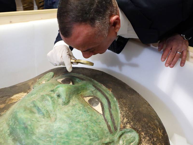 Secretary-General of the Egyptian Supreme Council of Antiquities Mostafa Waziri takes a close look at the ancient Egyptian artefact 'Green Sarcophagus' after it was returned from the Houston Museum of Natural Sciences, in Cairo, Egypt, 02 January 2023.  Egyptian Foreign Minister Sameh Shoukry and US Charge of Affairs Daniel Rubinstein attended a ceremony on 02 January to celebrate the handing over of the coffin lid known as the 'Green Sarcophagus' that was smuggled illegally outside of Egypt and recovered from the Houston Museum of Natural Sciences.  The artefact is three meters long carved in wood with columns of hieroglyphic texts dating back to the Late Period (664-332 BC).   EPA / KHALED ELFIQI