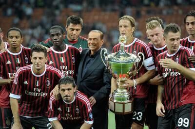 AC Milan players pose with chairman Berlusconi after winning the Berlusconi Trophy in Milan in 2011. Getty