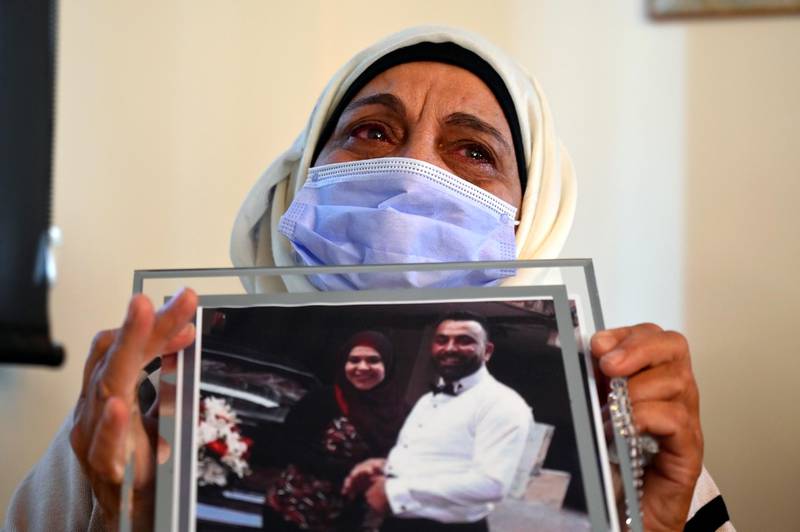 A woman reacts as she carries a picture of her son one of the victims of Beirut port explosion during the ceremony on the occasion of Mother's Day in Beirut, Lebanon. EPA