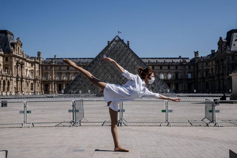 Syrian dancer and choreographer Yara al-Hasbani performs a dance in front of the Lourvre Museum's pyramid in Paris  on the 37th day of a strict lockdown in France to stop the spread of COVID-19.  AFP