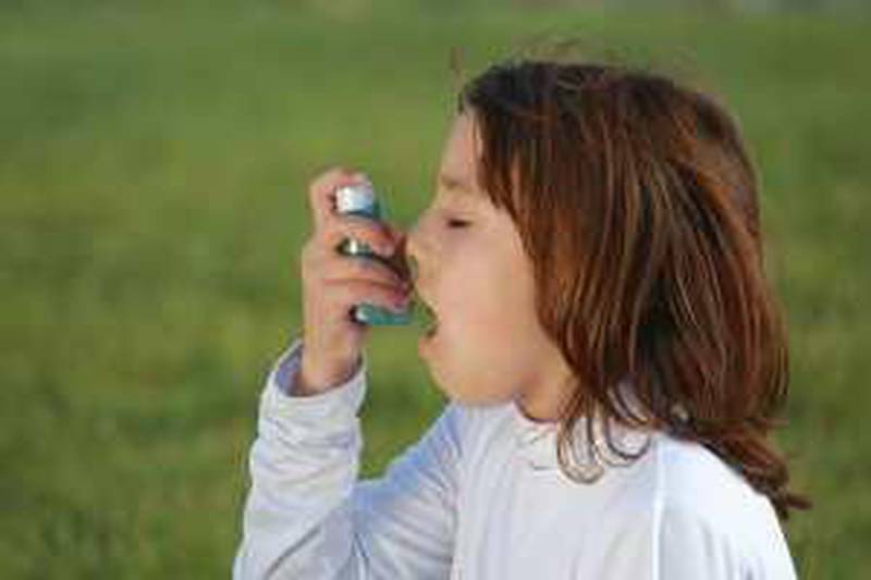 child using an asthma inhaleristockphoto.com