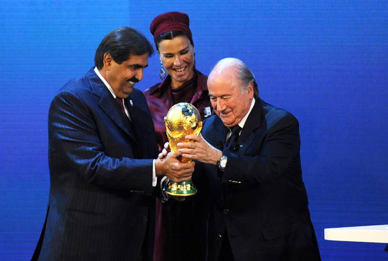 Emir of the State of Qatar Sheikh Hamad bin Khalifa Al-Thani (R) and his wife Sheikha Moza bint Nasser Al-Missned (C) receive the World Cup trophy from Fifa President Joseph Blatter after the official announcement that Qatar will host the 2022 World Cup on December 2, 2010 at the FIFA headquarters in Zurich.  AFP PHOTO / PHILIPPE DESMAZES / AFP PHOTO / PHILIPPE DESMAZES