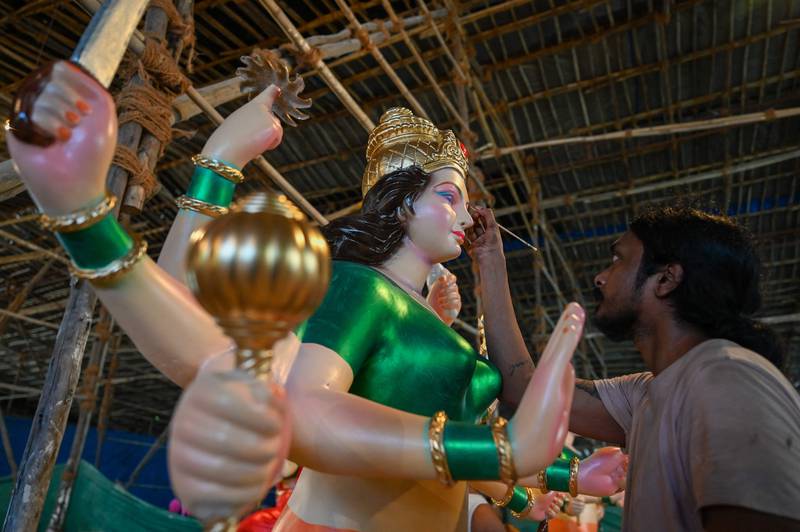 An artist in Mumbai reviews his work on the idol of Hindu goddess Durga ahead of the festival beginning this week. AFP