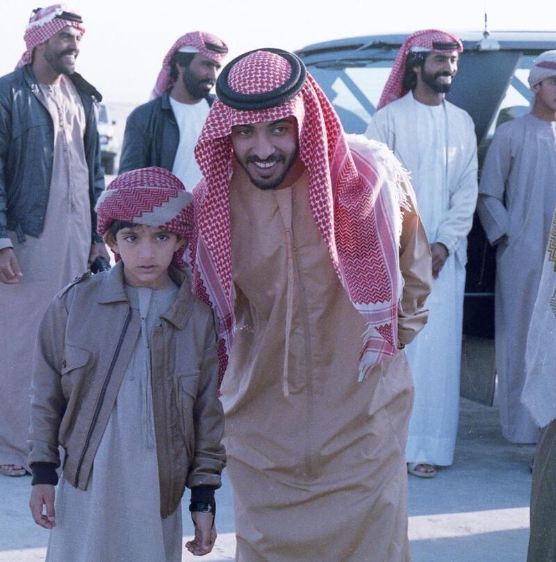 A young Sheikh Hamdan stands with Zayed Hamdan.